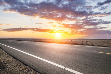 Fototapeta premium Asphalt highway road and desert with beautiful sky clouds natural landscape at sunset. Road trip.