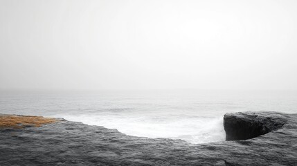 A serene coastal scene shrouded in fog and tranquility.