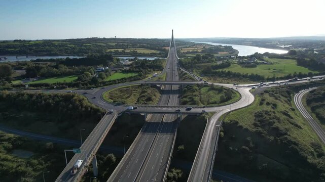 ireland Epic Locations drone flying over roundabout leading traffic to The Thomas Francis Meagher bridge over The River Suir Waterford Ireland at rush hour