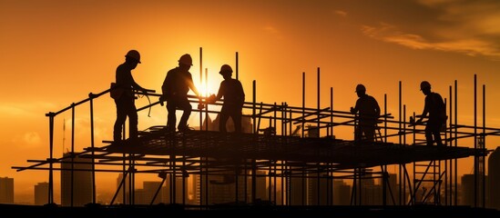 Silhouettes of Construction Workers at Sunset