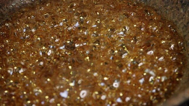 the process of caramelizing pecans in maple syrup to make pumpkin pie