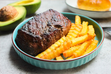 close up of barbeque grilled beef steak dish with french fries