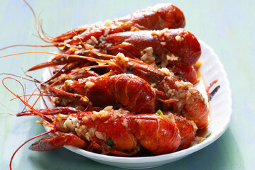 plate of traditional garlicky spicy sichuan red crawfish