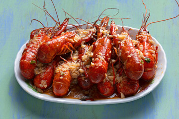 plate of traditional garlicky spicy sichuan red crawfish