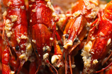 plate of traditional garlicky spicy sichuan red crawfish food background