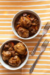 bowls of home made beef stew and dumplings English British food, comfort food, winter meal 