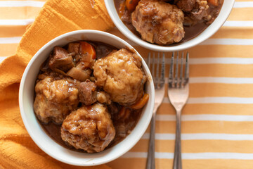 bowls of home made beef stew and dumplings English British food, comfort food, winter meal 