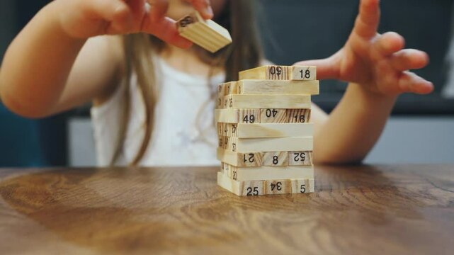 Close-up, Wooden block tower game. Memorable childhood experience was playing a wooden block tower game that created a cheerful, creative atmosphere, aiding development during those formative years