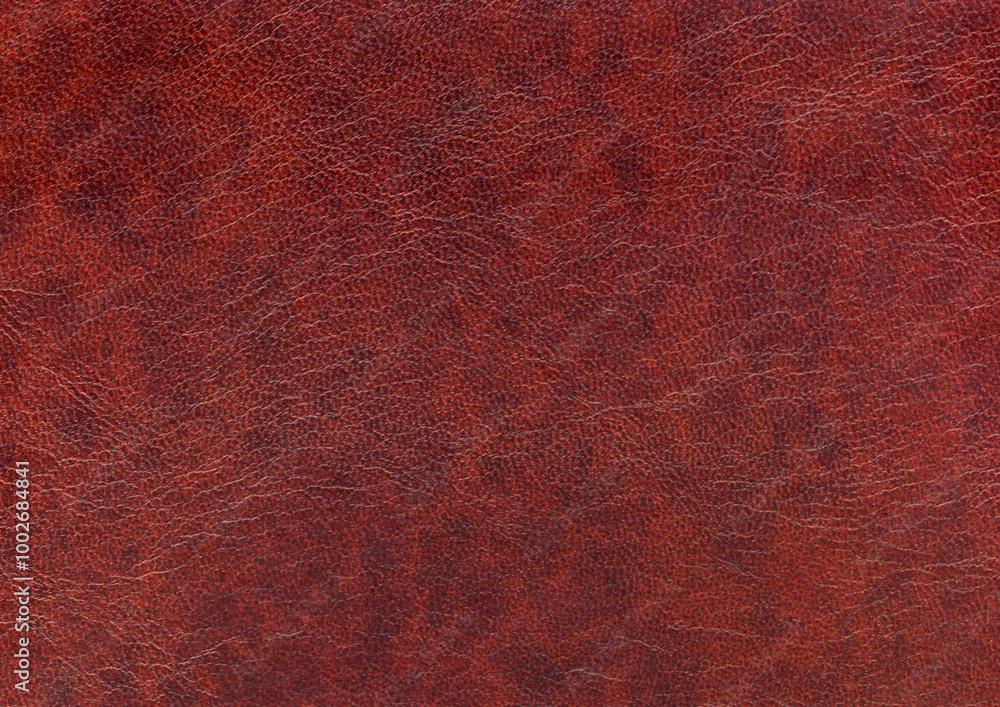 Wall mural burgundy background with artificial leather texture with blurred pattern