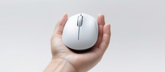 White Wireless Mouse in Hand