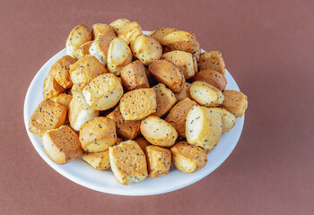 Christmas crisps with poppies on a plate on a brown background