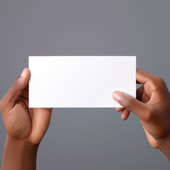 Two hands hold a blank card against a neutral background, offering a sense of potential and clean minimalism.