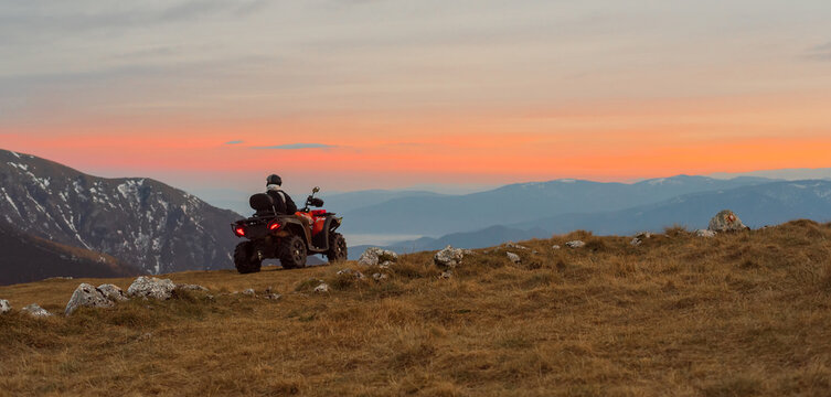 Riding quad bike atv on the mountain top adventure travel.