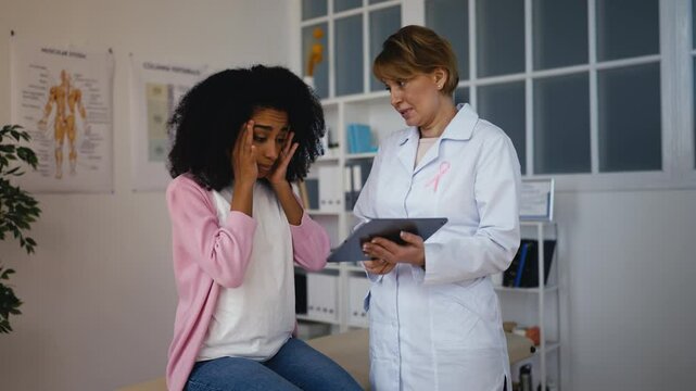 Doctor informing woman patient about breast check-up results, possible disease