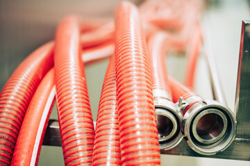 Flexible red hoses with metal nozzles