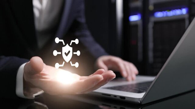 The glowing protection icon represents the importance of cybersecurity in protecting sensitive business data and systems, ensuring business continuity and safeguarding customer information