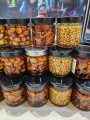 Assorted nuts with honey on the counter