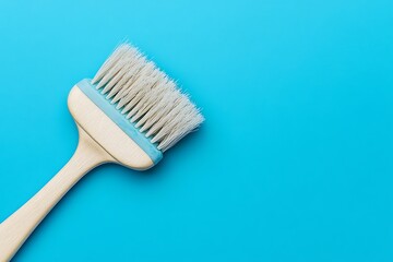 Paintbrush with White Bristles on a Blue Background