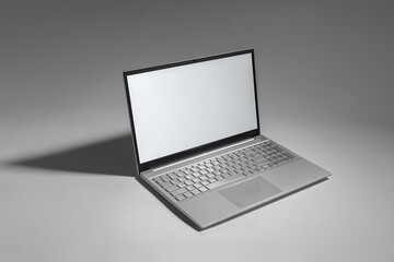 A laptop with a black keyboard and a silver screen