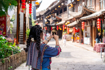 Young female tourist in traditional dress walking at Furong old Town, The famous tourist destination at Hunan Province, China