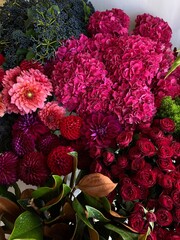 Beautiful fresh magnolia, hydrangea, dahlia, roses flowers arrangement in burgundy colors, vertical...