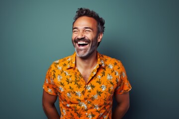 Fototapeta premium Portrait of a cheerful man in his 40s donning a trendy cropped top while standing against blank studio backdrop