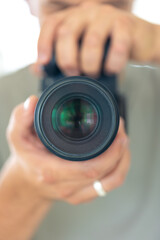 A man takes a photo of himself in the mirror with a camera. Close-up photo.