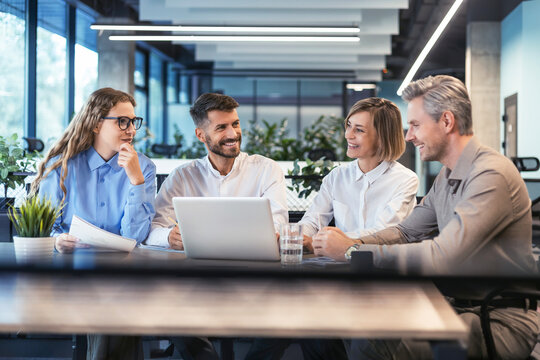 startup business team on meeting in modern bright office interior brainstorming, working on laptop and tablet computer.