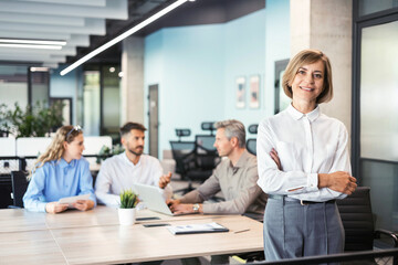 Face of beautiful middle aged woman on the background of business people.