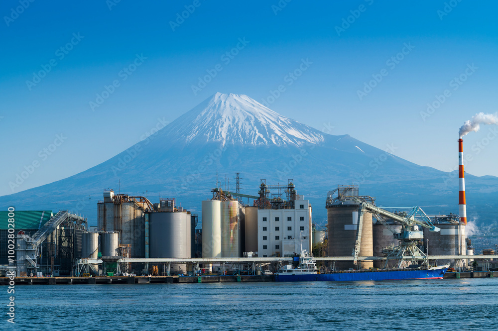 Wall mural japan industrial factory area with fuji mountain and blue sky background view from fishing port, fuj