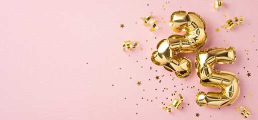 Golden number balloons 25 surrounded by confetti and ribbon on a vibrant pink background, creating a festive and celebratory atmosphere © ActionGP