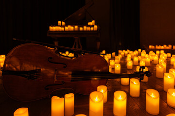 closeup of violin with lots of candles