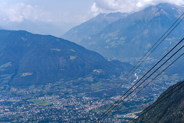 Aerial view of Italian City of Meran with Etsch Valley and Etsch River seen from mountain resort...