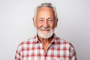 Obraz premium Portrait of a smiling man in his 70s wearing a comfy flannel shirt isolated in plain white digital canvas