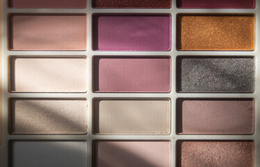 Horizontal eye shadow palette in sunlight close-up top view