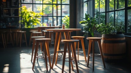 Obraz premium Side view of a group of stools in a restaurant, barrel table visible behind them, bright natural light from clear windows.