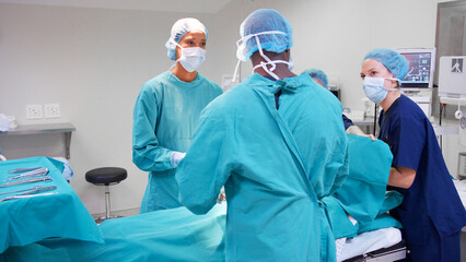 Multi-Cultural Surgical Team Working On Patient In Hospital Operating Theatre