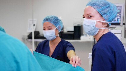 Multi-Cultural Surgical Team Working On Patient In Hospital Operating Theatre