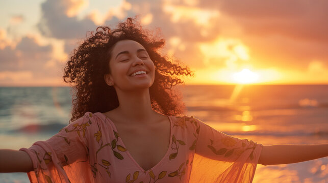 A woman joyfully enjoys the sunset on a tranquil beach, symbolizing peace, freedom, and bliss amidst the stunning backdrop of the glowing horizon.