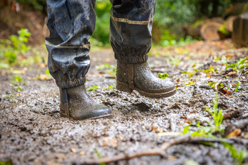 Child in welly boots, jump, jumping in mud.
