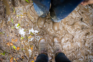 Child in welly boots, jump, jumping in mud.