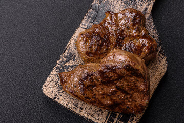 Juicy beef steak grilled with salt, spices and herbs