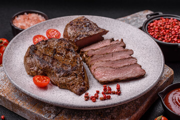 Juicy beef steak grilled with salt, spices and herbs