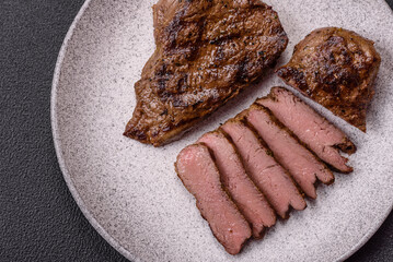 Juicy beef steak grilled with salt, spices and herbs