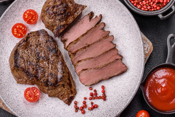 Juicy beef steak grilled with salt, spices and herbs