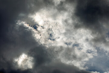 Fototapeta premium Gathering Storm Clouds Illuminated by the Sun