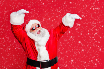 Portrait of his he nice attractive cheerful cheery glad careless bearded Santa having fun rejoicing fairy eve noel celebratory isolated over bright vivid shine red background