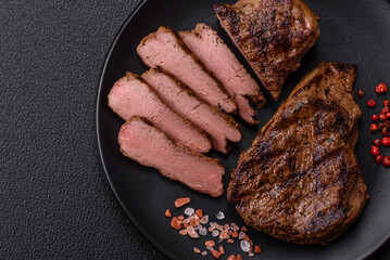 Juicy beef steak grilled with salt, spices and herbs