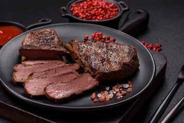 Juicy beef steak grilled with salt, spices and herbs