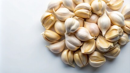 A close-up aerial shot of organic peeled garlic on a white background.